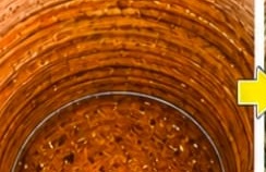 Water tank interior heavily coated with rust-coloured scale